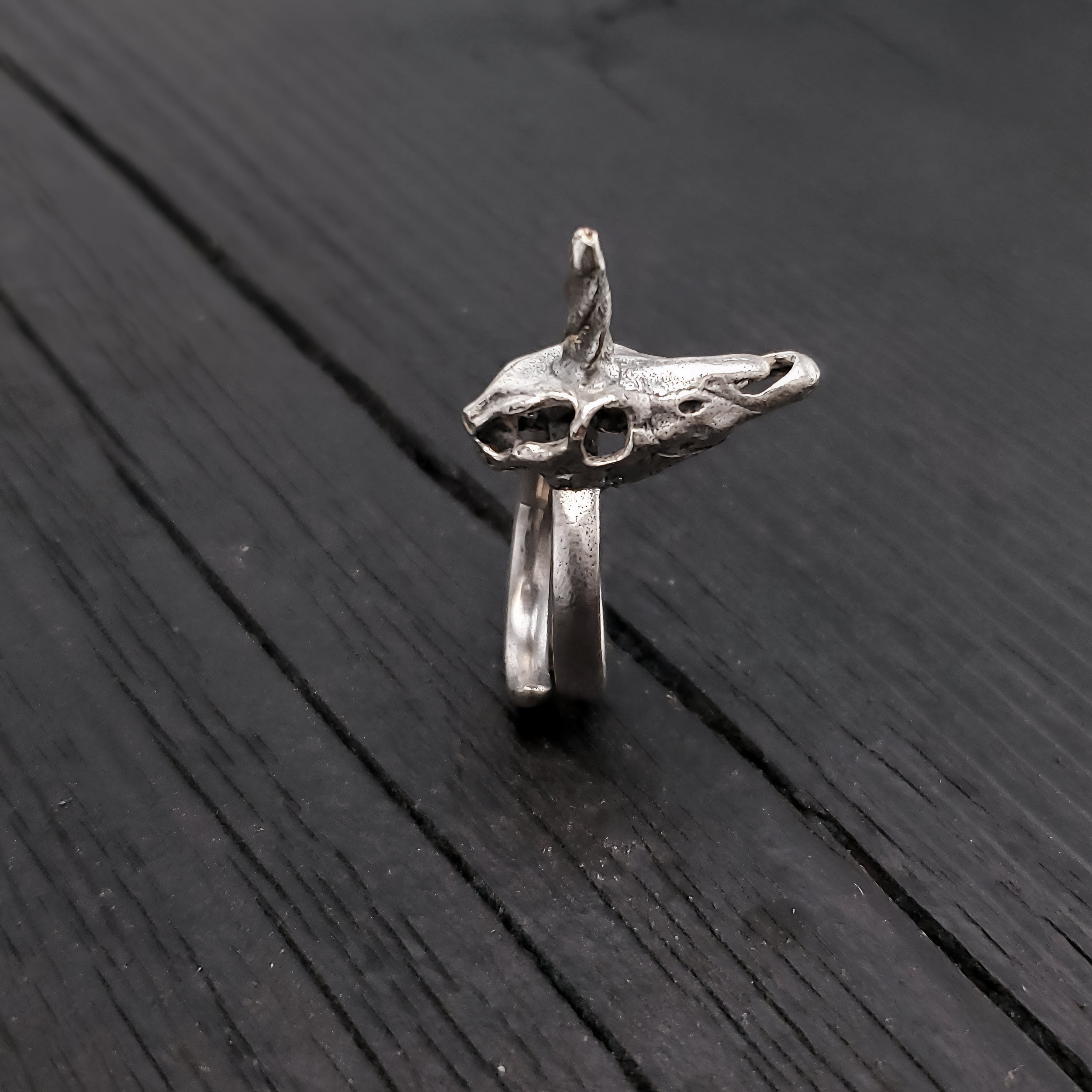 My little unicorn skull ring is cast in solid silver plated bronze, oxidized in the recesses to show off the fine details. It measures a mere 15/16" (24mm) long and 3/8" (10mm) at its widest point.