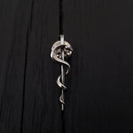 Silver snake coiled on black background, sleek texture | Moon Raven