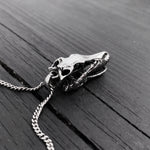 Skull necklace on rustic wooden table, intricate design | Moon Raven