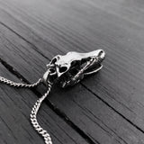 Skull necklace on rustic wooden table, intricate design | Moon Raven