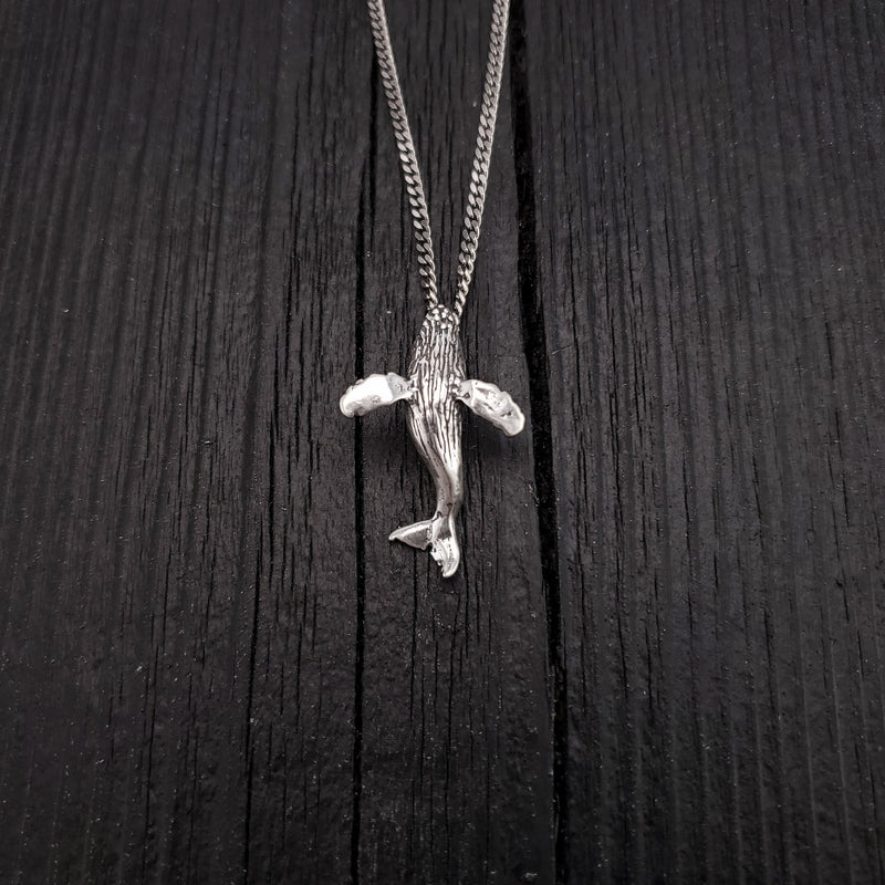 Pendant width: 7/8 Inches; height: 1 1/4 Inches. My breaching humpback whale is the perfect gift for anyone that appreciates these ocean mammals. This whale is completely three dimensional. It is cast in .925 Sterling Silver with a integrated bail.